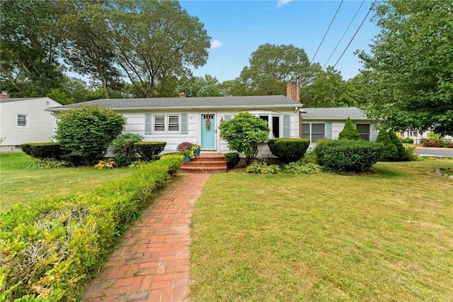 ranch-style home with a front lawn and a chimney