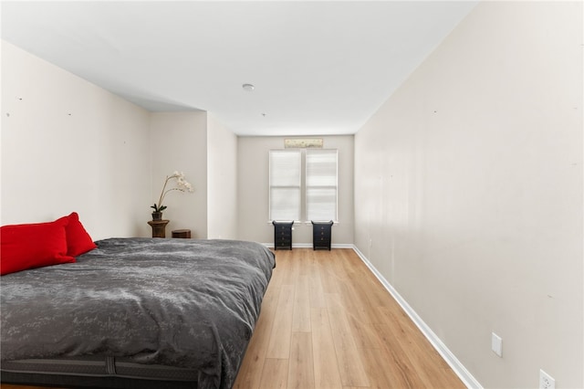 bedroom featuring light wood-type flooring and baseboards