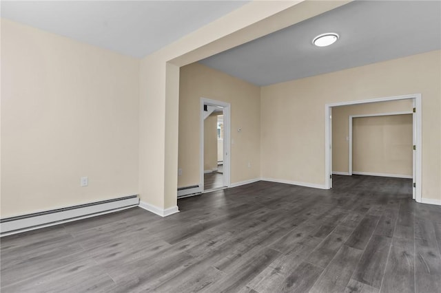 empty room with dark wood-style floors, a baseboard radiator, baseboards, and a baseboard heating unit