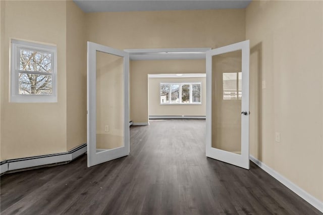 corridor with a baseboard heating unit, french doors, dark wood finished floors, and baseboard heating