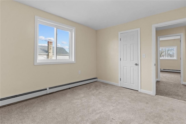 unfurnished bedroom featuring a baseboard heating unit, carpet floors, baseboard heating, and baseboards