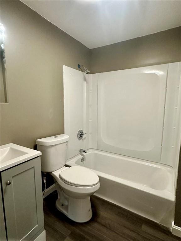 full bath featuring bathing tub / shower combination, vanity, toilet, and wood finished floors