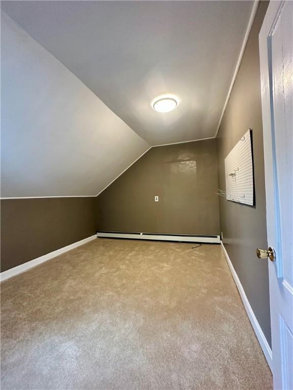 bonus room with carpet floors, baseboards, a baseboard heating unit, and vaulted ceiling