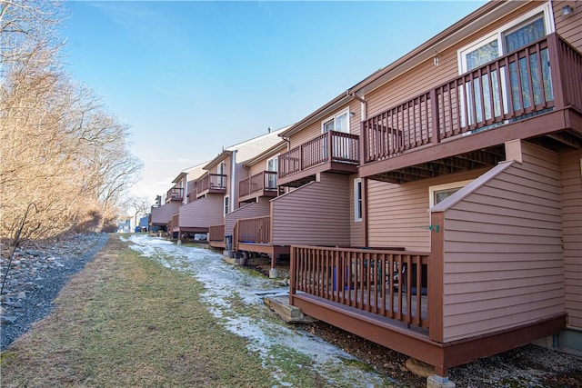 exterior space with driveway, a residential view, and a wooden deck