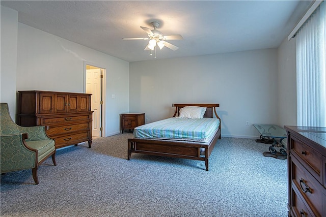 carpeted bedroom with a ceiling fan and baseboards