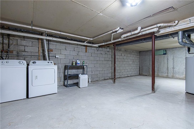 unfinished below grade area with water heater and washing machine and clothes dryer