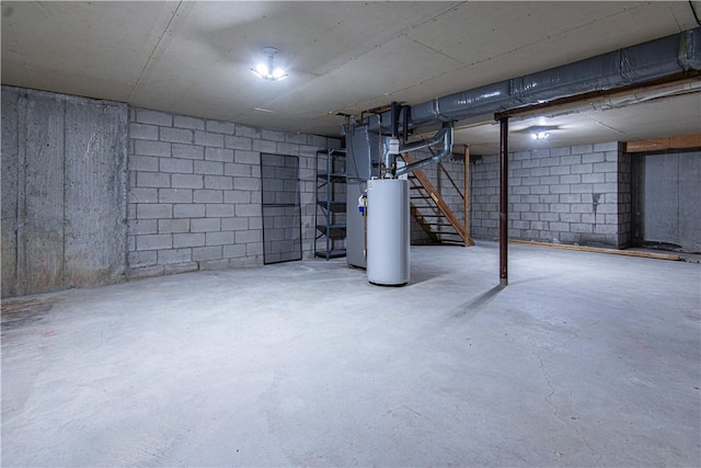 unfinished below grade area featuring gas water heater and stairway