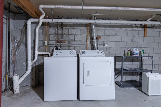 clothes washing area featuring laundry area and washing machine and clothes dryer