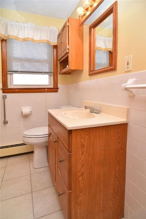 bathroom with tile patterned flooring, toilet, wainscoting, vanity, and a baseboard radiator