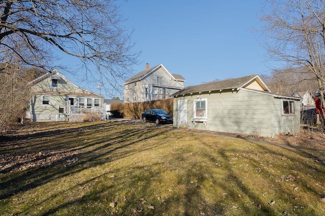 rear view of house with a lawn and fence