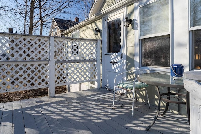 wooden terrace featuring outdoor dining area