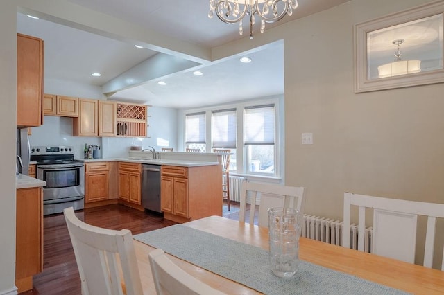 kitchen featuring dark wood-style flooring, stainless steel appliances, an inviting chandelier, a sink, and beamed ceiling