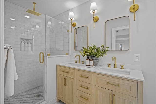 full bath with double vanity, a shower stall, and a sink