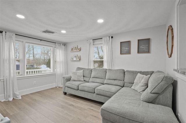 living area with light wood-type flooring, baseboards, visible vents, and recessed lighting