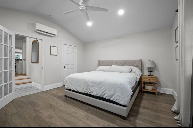 bedroom with lofted ceiling, ceiling fan, wood finished floors, baseboards, and an AC wall unit