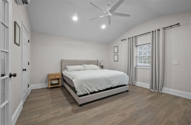 bedroom featuring a ceiling fan, vaulted ceiling, baseboards, and wood finished floors