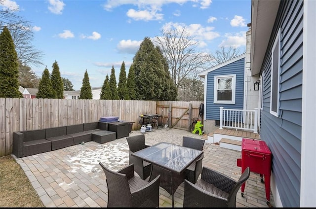 view of patio / terrace featuring a fenced backyard, outdoor lounge area, and outdoor dining space