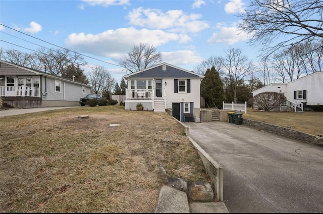 view of front of home with a porch and a front yard