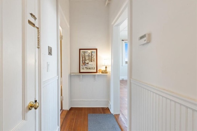 corridor with wainscoting and wood finished floors