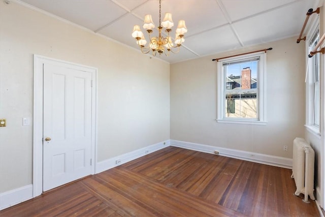 unfurnished room featuring radiator, ornamental molding, wood finished floors, a chandelier, and baseboards