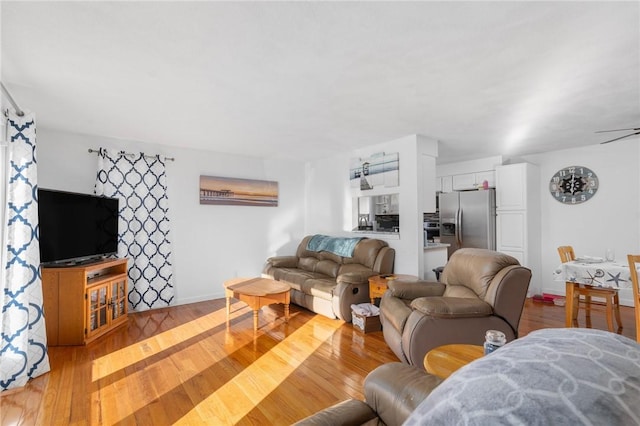 living area with light wood finished floors and baseboards