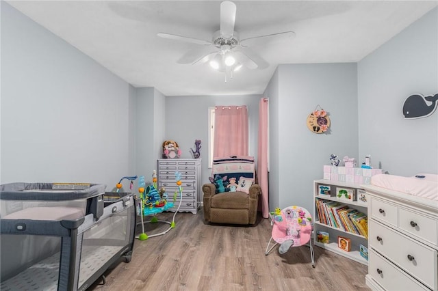 recreation room with a ceiling fan and wood finished floors