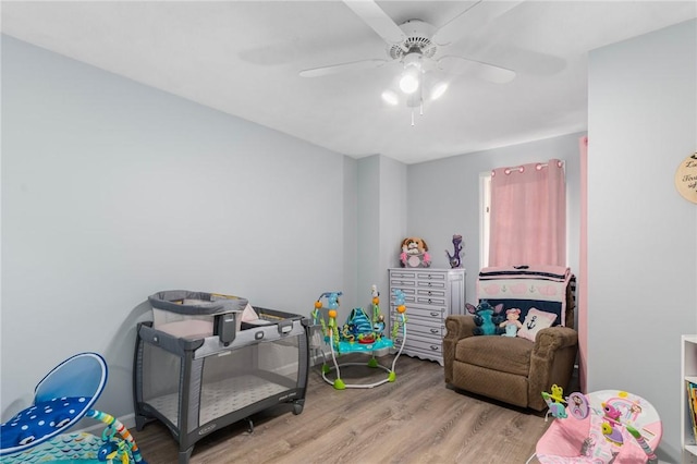 rec room with ceiling fan and wood finished floors