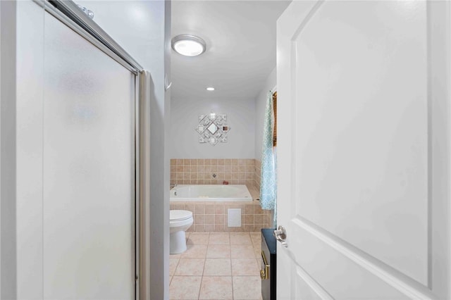 bathroom with a stall shower, toilet, a bath, and tile patterned floors