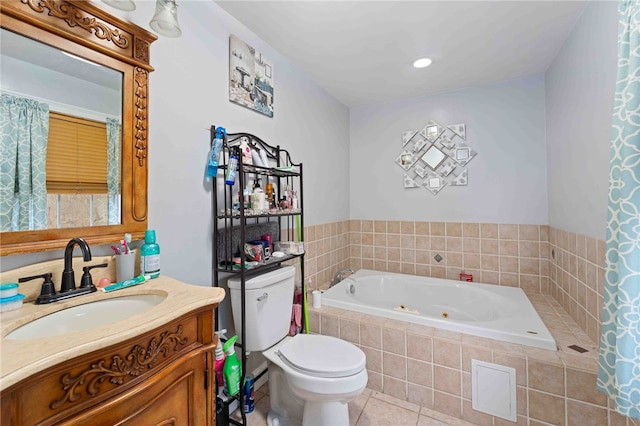 full bath featuring a jetted tub, vanity, toilet, and tile patterned floors