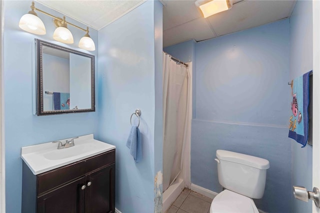 bathroom with toilet, curtained shower, tile patterned flooring, and vanity