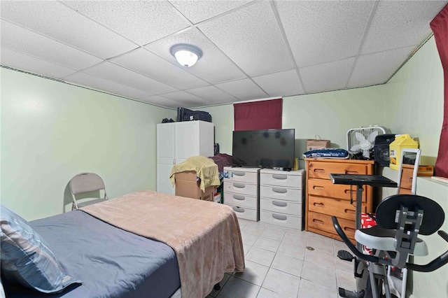 bedroom featuring light tile patterned floors and a paneled ceiling