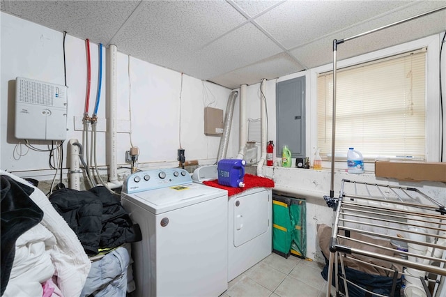 clothes washing area with washer and dryer, laundry area, electric panel, and light tile patterned floors