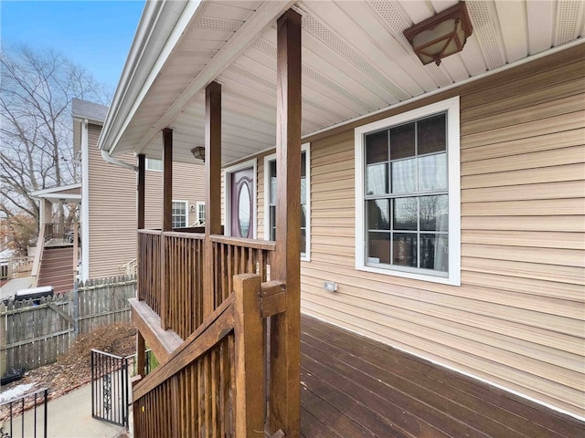 wooden terrace featuring fence