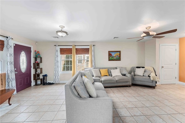 living area with light tile patterned floors, baseboards, and visible vents