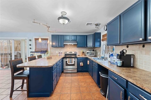 kitchen featuring blue cabinetry, stainless steel appliances, visible vents, a sink, and under cabinet range hood