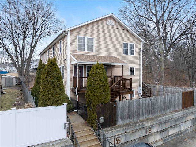 view of front of house featuring a fenced front yard and stairs