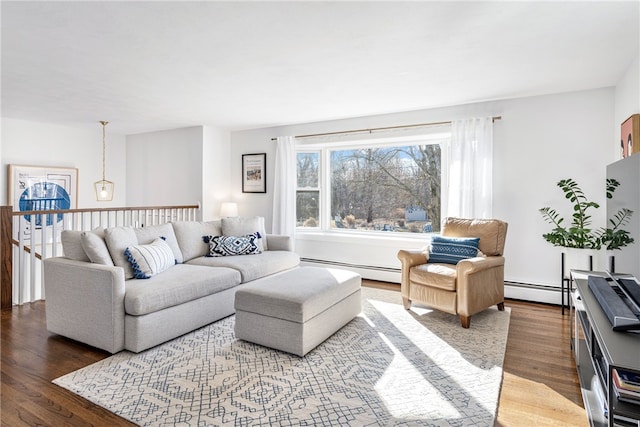 living room featuring a baseboard heating unit and wood finished floors