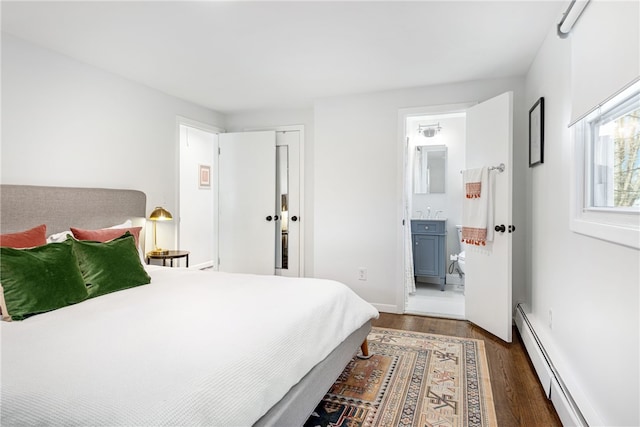 bedroom with a baseboard heating unit, baseboards, connected bathroom, and dark wood-style flooring