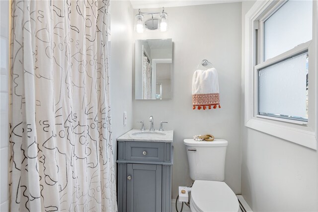 full bathroom with vanity, curtained shower, and toilet