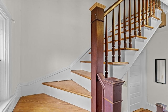 stairs featuring wood finished floors