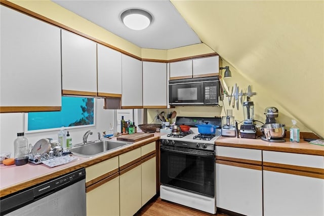 kitchen with range with gas cooktop, light countertops, stainless steel dishwasher, black microwave, and a sink