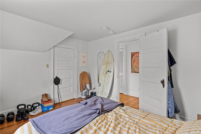 bedroom with baseboards and wood finished floors