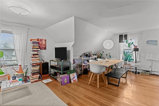 office area featuring a wealth of natural light, vaulted ceiling, and wood finished floors