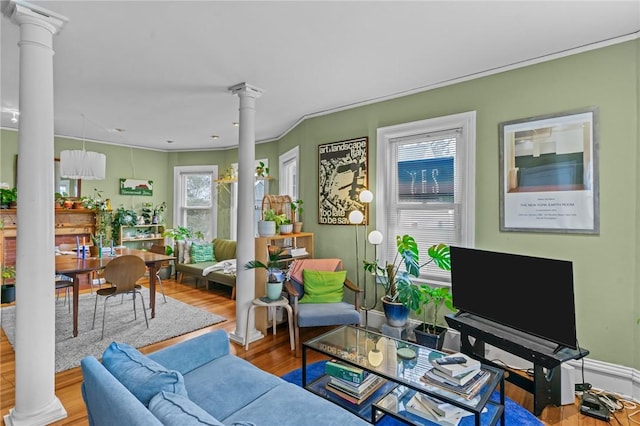 living room featuring wood finished floors and ornate columns