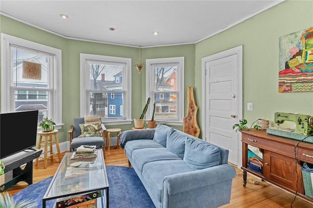 living area with ornamental molding, recessed lighting, baseboards, and wood finished floors