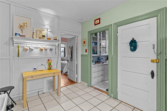 foyer featuring tile patterned flooring and wainscoting