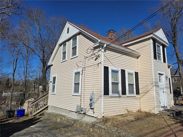 view of side of home with a chimney