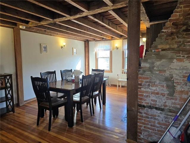 dining room featuring baseboards and hardwood / wood-style flooring