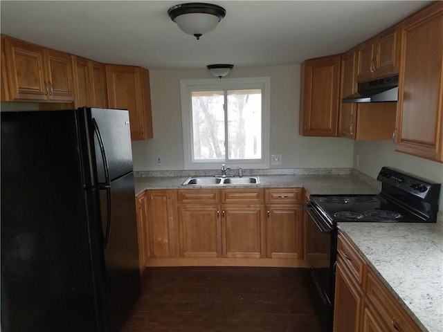 kitchen with black appliances, brown cabinetry, a sink, and under cabinet range hood