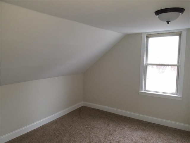 bonus room featuring carpet, lofted ceiling, and baseboards